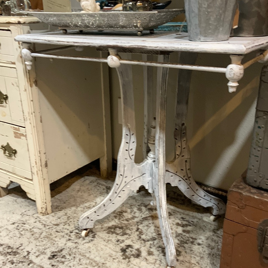 White distressed table on casters